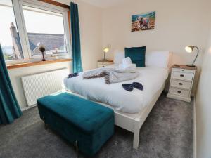 a small bedroom with a bed and a window at Crown Cottage in Dunfermline
