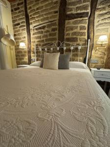a large bed in a room with a brick wall at APARTAMENTOS La Colmena APT - 1 - AT-CC-00248 in Gata