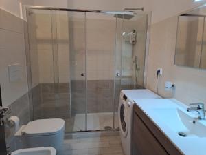 a bathroom with a shower and a toilet and a sink at Medoro Gioiosa 2 in Gioiosa Marea +23 photos