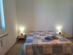 a bedroom with a bed with two towels on it at Medoro Gioiosa 2 in Gioiosa Marea