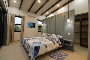 a bedroom with a bed and a tv in it at Sunset Oasis Waterfront in Maya Beach +15 photos