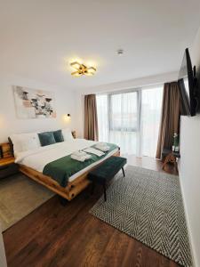 a bedroom with a large bed with a green blanket at Hotel B4 in Oradea