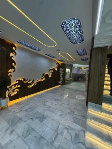 a lobby of a building with a wall with yellow and blue lights at Hôtel kairouan in Fez