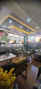 a restaurant with couches and tables and chairs at Blue Amedist Hotel in Istanbul