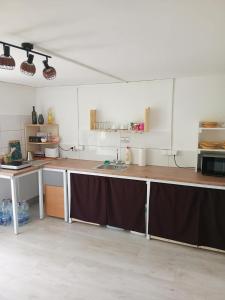 a kitchen with a table and a counter top at Pehely Vendégház in Lesencetomaj