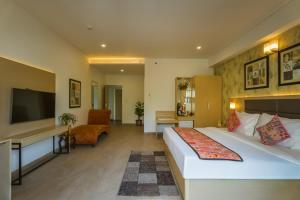 a hotel room with a bed and a desk at Tripli Hotels Shourya Residency in Udaipur