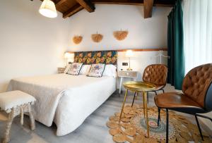 a bedroom with a bed and a table and chairs at La Cabaña de La Nina in Beceña +12 photos