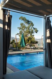 a view of a swimming pool through a window at La Cabaña de La Nina in Beceña