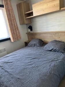a bed with two pillows in a bedroom at domaine de litteau in Litteau
