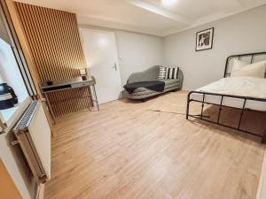 a room with a bed and a chair in it at Drei Linden Rosenwall in Wolfenbüttel