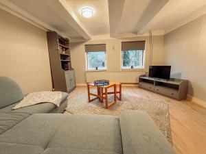 a living room with a couch and a table at Drei Linden Rosenwall in Wolfenbüttel +3 photos