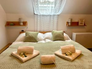 a bedroom with a bed with two pillows on it at Rezidence - HAMR in Nové Hrady