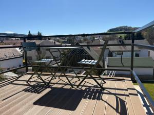 a chair sitting on top of a deck at Apartmán Ve Štítu in Lomnice nad Popelkou