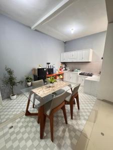 a kitchen with a table and chairs in a room at Villa FiFa in Blimbing