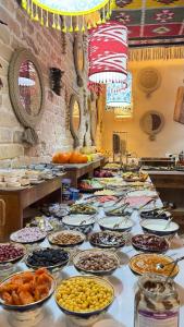 a buffet with many bowls of food on a table at Hotel Old Heritage in Tashkent