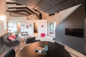 a living room with a table and a couch at ROSTAGNI 1834 apt with pool in the Barolo region in Novello