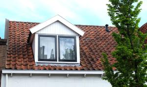 a window on the roof of a house at Zuidzuidwest in Zierikzee +7 photos