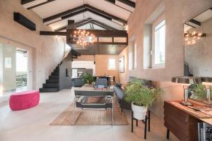 a living room with a couch and a table at ROSTAGNI 1834 apt with pool in the Barolo region in Novello