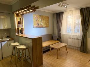 a living room with a couch and a table at A & A GLOBAL PROPERTY RENTALs in Yerevan +6 photos