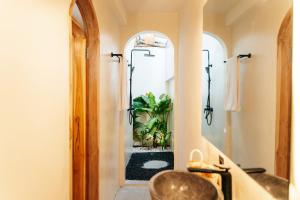a bathroom with a sink and a mirror at Villa Allegra in Mantaak