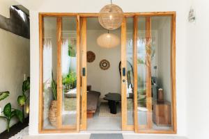 a pivot door in a living room with glass at Villa Allegra in Mantaak +23 photos