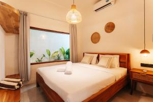 a bedroom with a bed and a large window at Villa Allegra in Mantaak