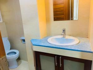 a bathroom with a sink and a toilet at Crystal Sand Mount Lavinia in Mount Lavinia +17 photos