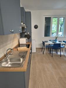 a kitchen with a sink and a table with chairs at NonSoloCitta' in Torrette