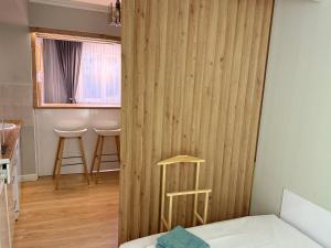 a room with a wooden partition with a stool at A & A GLOBAL PROPERTY RENTALs in Yerevan