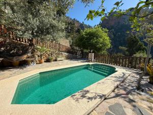 a swimming pool in a yard with a fence at Sa Màniga in Fornalutx
