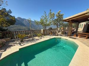 a swimming pool with a view of a mountain at Sa Màniga in Fornalutx