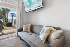 a living room with a couch and a tv at Bluehavenon30a-Between Rosemary & Alys Beach -Steps to Beach & Dining-Sleeps 3 in Rosemary Beach