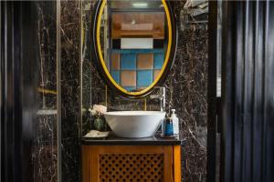 a bathroom with a sink and a mirror at Overnight Cruise in Hai Phong