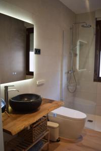 a bathroom with a sink and a toilet and a shower at OE concept in Guernica y Luno +39 photos