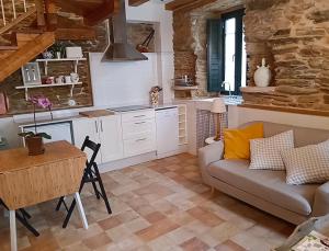 a living room with a couch and a table at O Recuncho de Celia in Foz