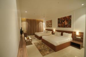 a hotel room with a bed and a couch at The Grand Icon in Chandrapur +119 photos