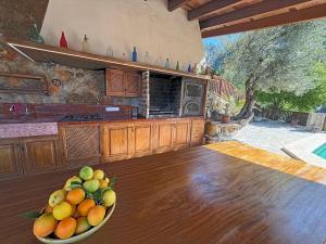 a bowl of fruit on a table in a kitchen at Sa Màniga in Fornalutx