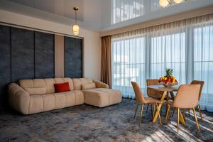a living room with a large couch and a table at NOYA - Hotel Building Stefan Resort II in Mamaia Sat/Năvodari +52 photos