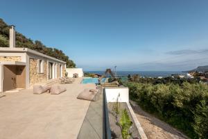 a villa with a view of the ocean at Villa Afroditi - Sfinari in Áyios Nikólaos