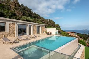 a villa with a swimming pool and a house at Villa Afroditi - Sfinari in Áyios Nikólaos