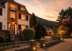 a house with a staircase leading up to the front yard at Villa Ardoise direkt an der Mosel zwischen Cochem und Koblenz in Brodenbach