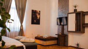 a room with two beds and a tv in it at Tivoli Apartament in Sebeş