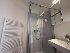 a bathroom with a shower and a sink at Strandhotel - 19 "Sardinenbüchse" in Dahme +22 photos