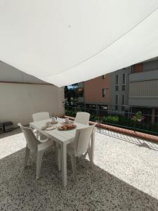 a white dining table and chairs on a balcony at Casa Spartaco in Certaldo
