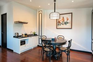 a kitchen and dining room with a table and chairs at BAAN 125 STAY Phuket in Phuket