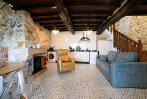 a living room with a blue couch and a chair at Apartamentos La Cabaña del Cerro Alto in Beceña +22 photos