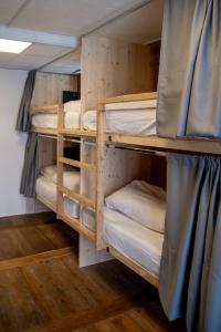 a bunk bed room with four bunk beds in it at BodyGo Hostel Briançon in Briançon
