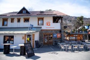 a restaurant with tables and chairs in front of a building at BodyGo Hostel Briançon in Briançon