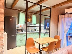 a kitchen with a table and chairs and a refrigerator at DG kores in Metsovo