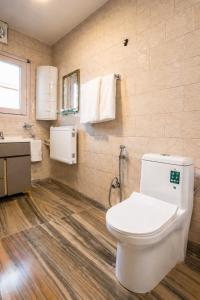 a bathroom with a toilet and a sink at Dar-e-Shafi in Srinagar +22 photos